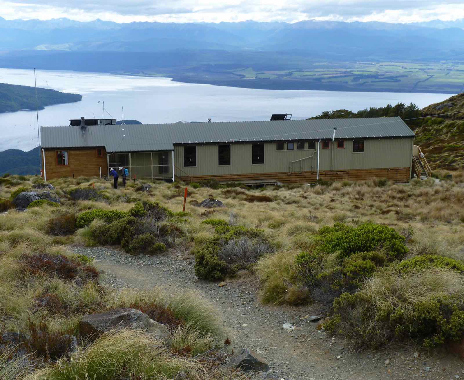 A long hut on an open hillside above Lake Te Anau